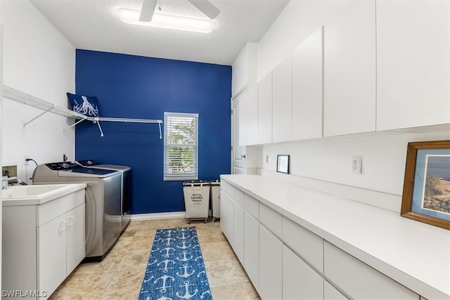 laundry area featuring ceiling fan, light tile flooring, cabinets, electric dryer hookup, and separate washer and dryer