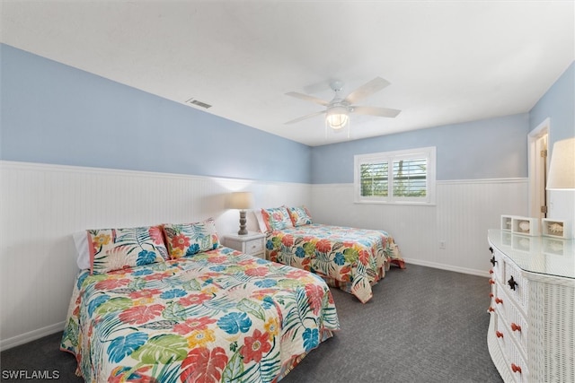 bedroom featuring ceiling fan and dark colored carpet