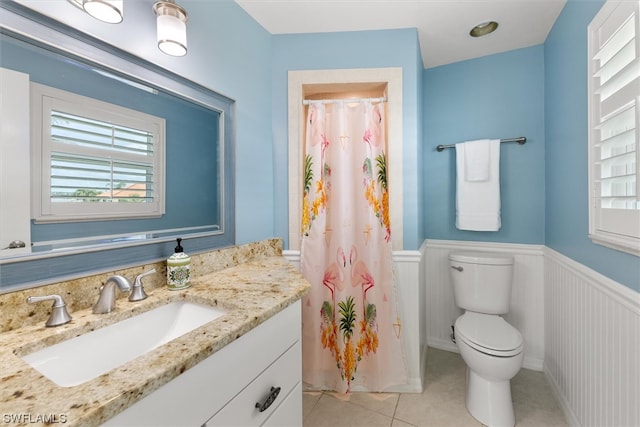 bathroom featuring toilet, large vanity, and tile floors