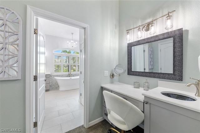 bathroom featuring vanity, a notable chandelier, tile flooring, and a bath