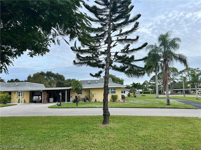 view of front facade with a carport and a front yard