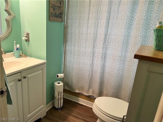 bathroom featuring vanity, hardwood / wood-style flooring, toilet, and a shower with shower curtain