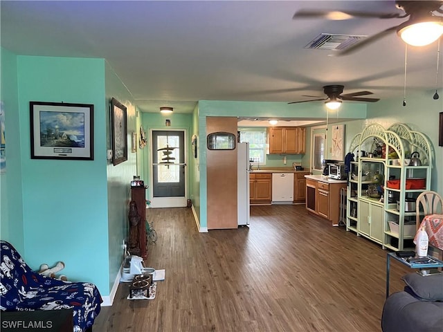 kitchen featuring white appliances, dark hardwood / wood-style floors, and ceiling fan