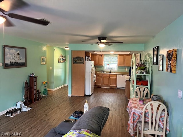 living room with ceiling fan, sink, and dark hardwood / wood-style flooring