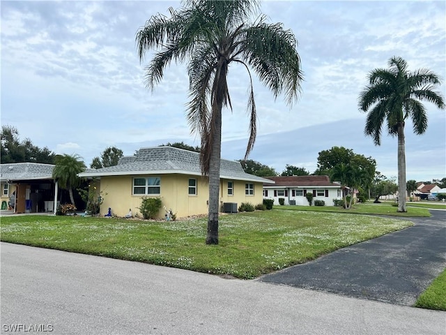 single story home featuring a front yard and central air condition unit