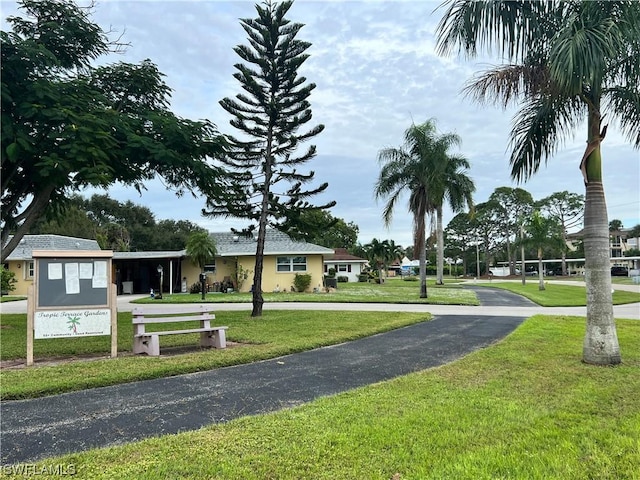 view of property's community with a lawn