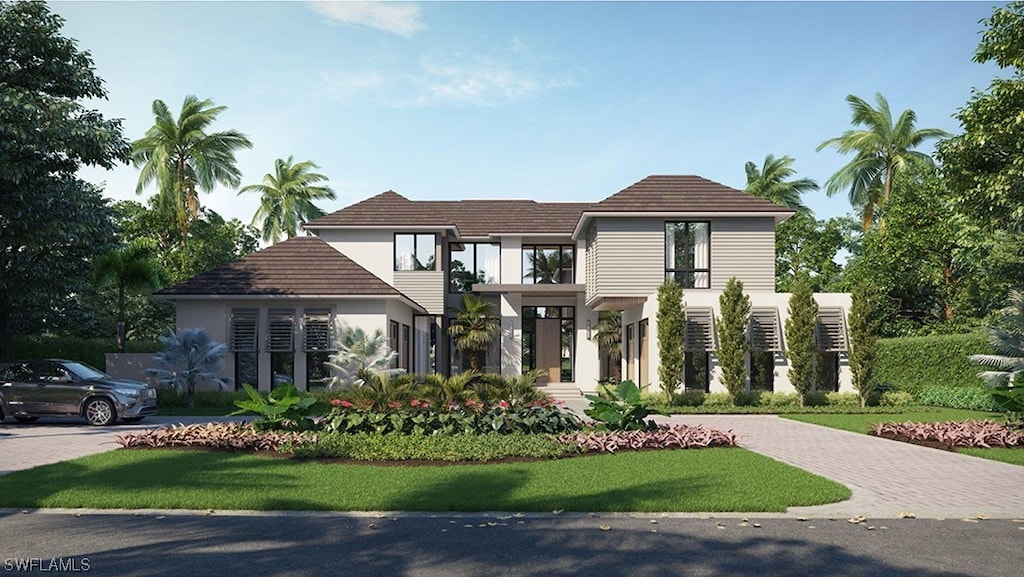 view of front of home featuring decorative driveway and stucco siding