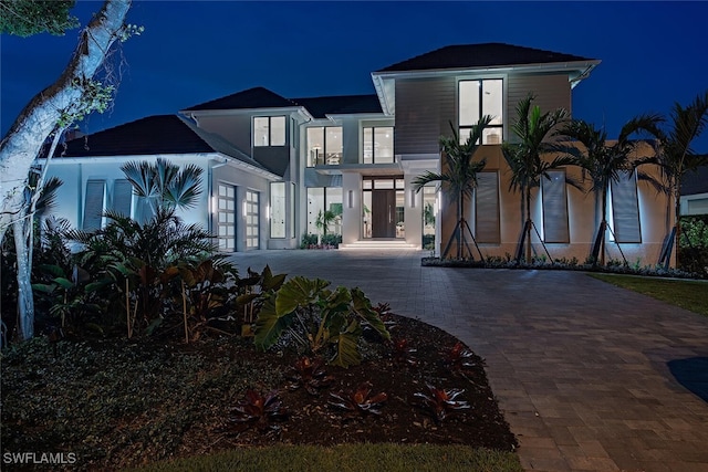 view of front of property with an attached garage and decorative driveway