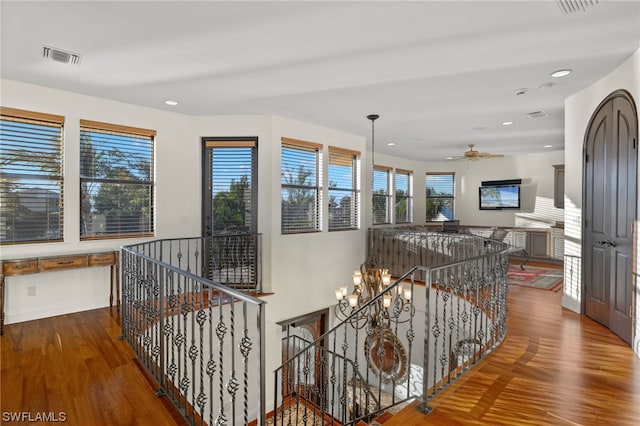 hall featuring a chandelier and dark wood-type flooring