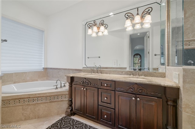 bathroom featuring oversized vanity, a relaxing tiled bath, tile floors, and dual sinks