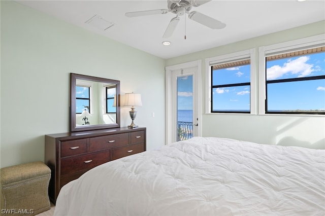 bedroom with access to exterior, ceiling fan, and multiple windows