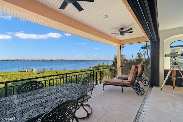 view of patio / terrace with a balcony, a water view, and ceiling fan