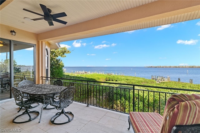 balcony with a water view and ceiling fan