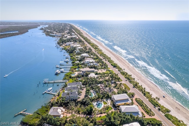 bird's eye view featuring a water view and a beach view