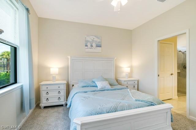 bedroom featuring light carpet, visible vents, and baseboards