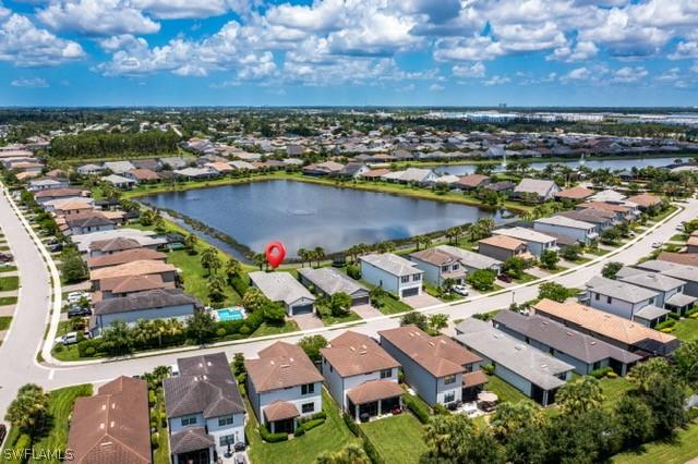 drone / aerial view with a water view and a residential view