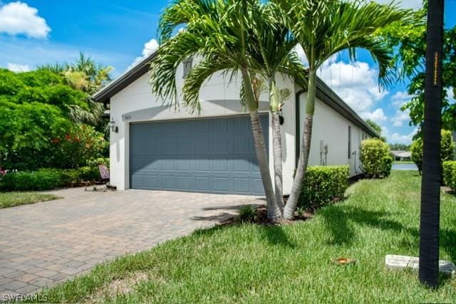 garage featuring decorative driveway