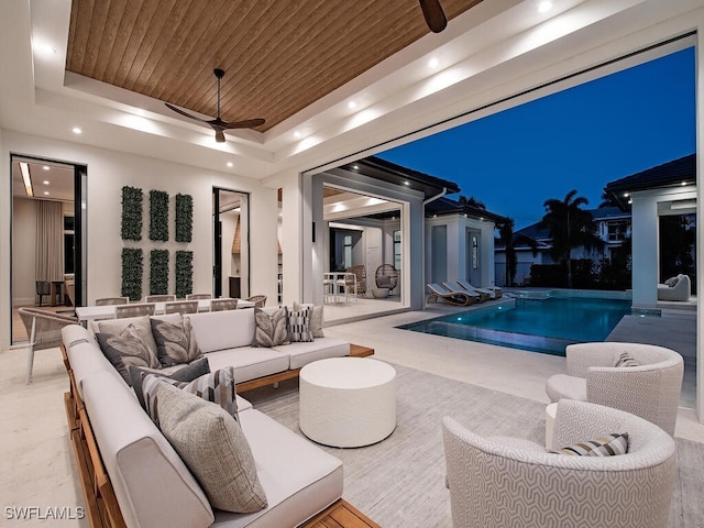 view of swimming pool with ceiling fan and a jacuzzi