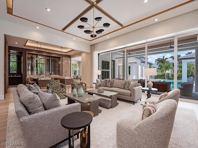 living room featuring light hardwood / wood-style floors, a notable chandelier, and a healthy amount of sunlight