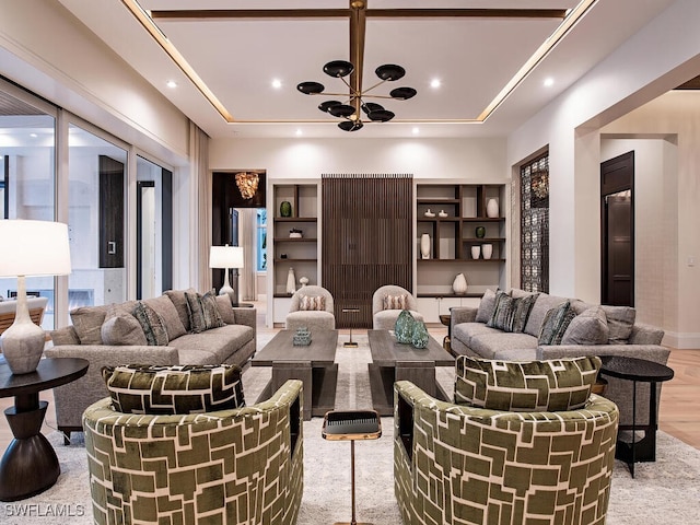 living room featuring light hardwood / wood-style floors and an inviting chandelier