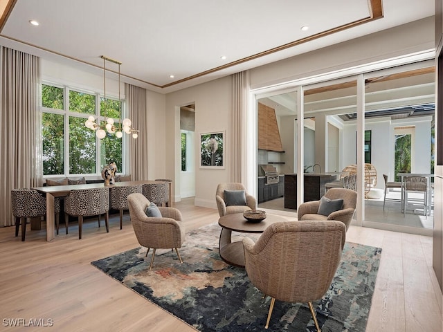 interior space featuring a chandelier, light hardwood / wood-style flooring, and ornamental molding