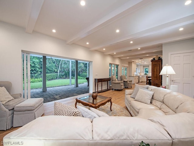 living room with beamed ceiling and light hardwood / wood-style floors