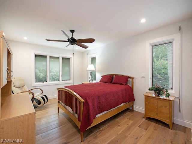 bedroom with ceiling fan and light hardwood / wood-style flooring