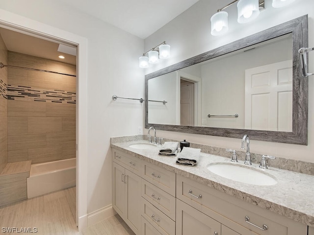 bathroom with vanity and tiled shower / bath