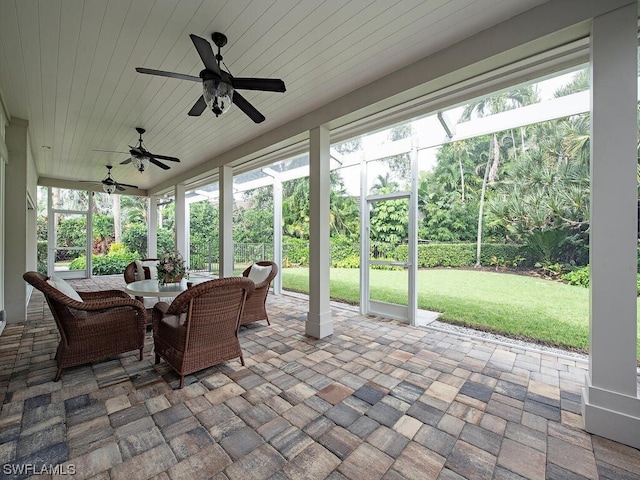 sunroom featuring ceiling fan