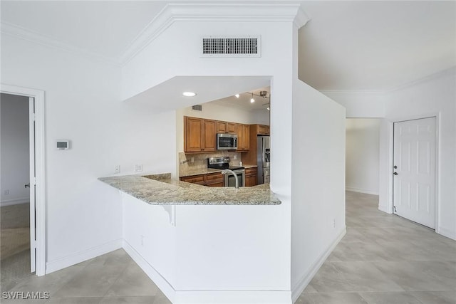 kitchen featuring tasteful backsplash, light stone counters, ornamental molding, appliances with stainless steel finishes, and kitchen peninsula