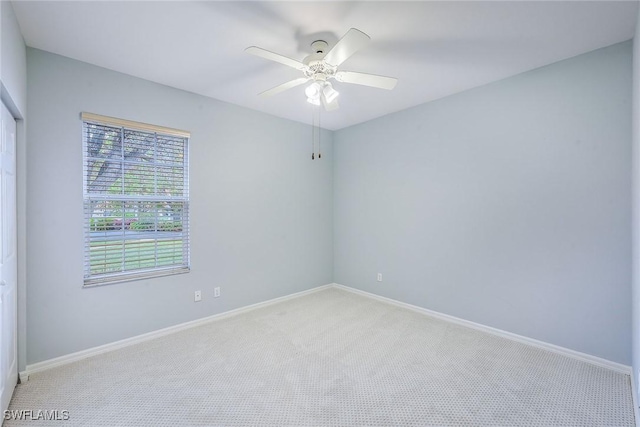 empty room featuring light carpet and ceiling fan