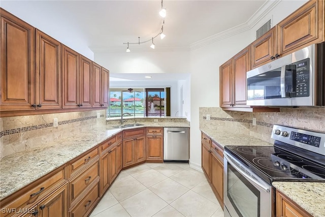 kitchen featuring light tile patterned flooring, appliances with stainless steel finishes, sink, and decorative backsplash