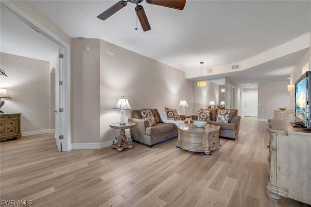 living room featuring ceiling fan and light hardwood / wood-style floors