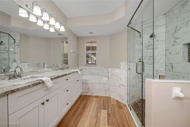 bathroom with separate shower and tub, hardwood / wood-style floors, and vanity