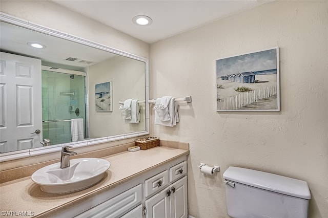 bathroom featuring toilet and vanity with extensive cabinet space