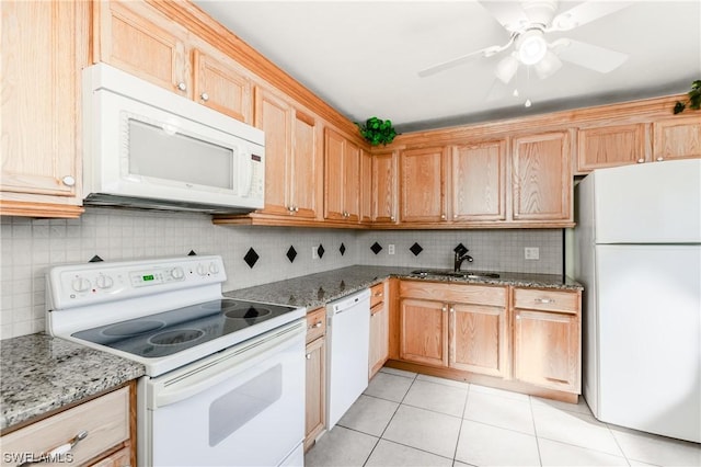 kitchen featuring light tile patterned flooring, stone countertops, tasteful backsplash, sink, and white appliances