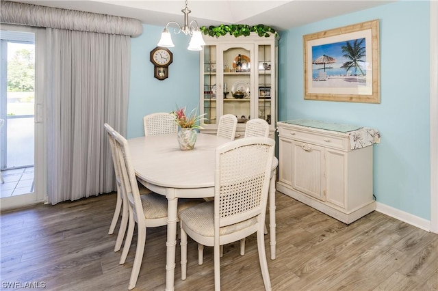 dining space featuring a notable chandelier and light hardwood / wood-style floors