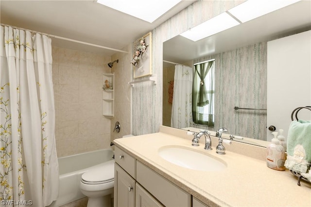 full bathroom with a skylight, vanity, shower / bath combination with curtain, and toilet