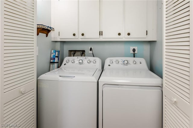 laundry room with cabinets and washing machine and dryer