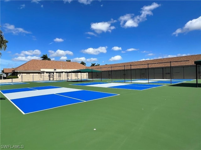 view of tennis court featuring basketball hoop