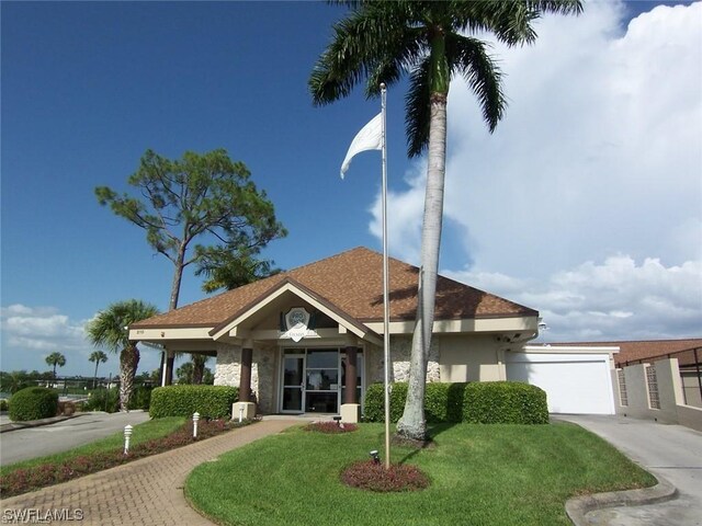 view of front of property featuring a garage and a front yard