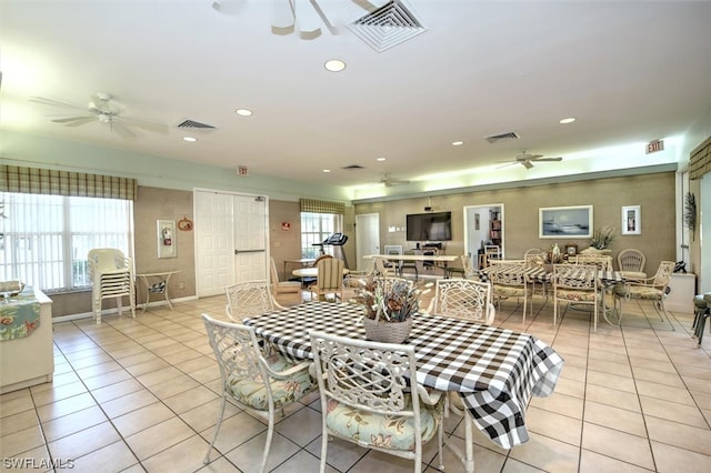 tiled dining area with ceiling fan