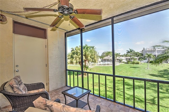 sunroom / solarium featuring ceiling fan