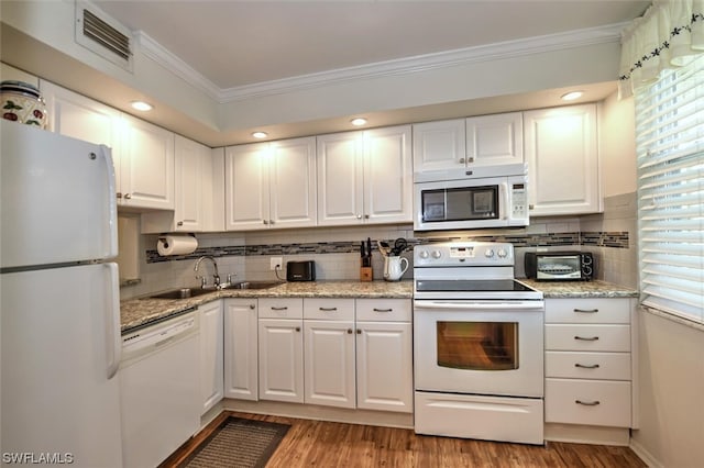 kitchen with white cabinets, ornamental molding, white appliances, and light wood-type flooring