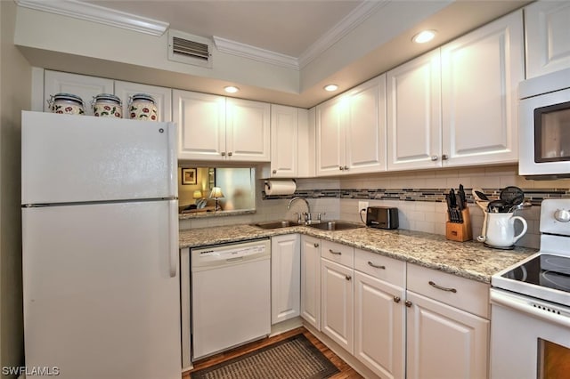 kitchen featuring white appliances, sink, ornamental molding, white cabinets, and backsplash