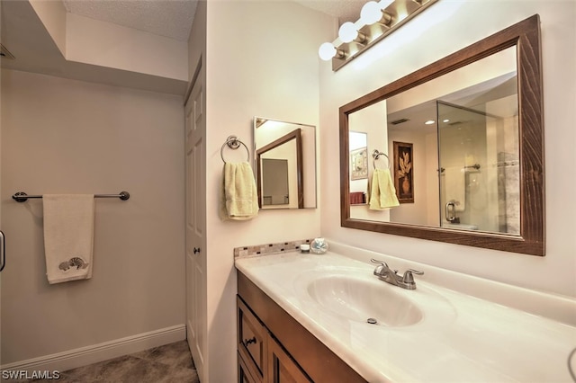 bathroom with oversized vanity, a textured ceiling, and tile floors