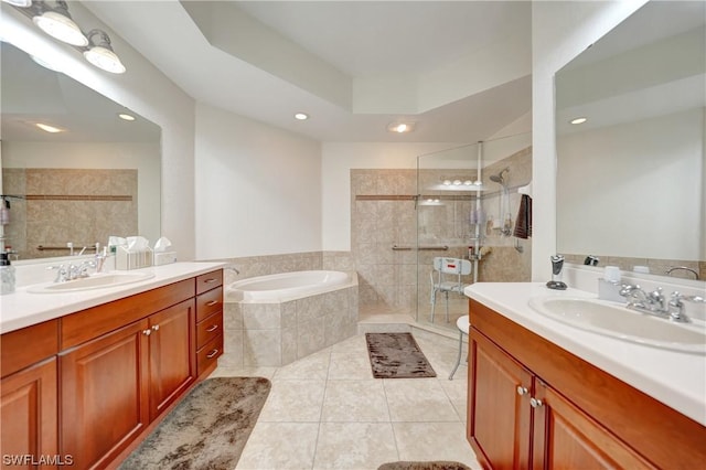 bathroom with tile patterned flooring, vanity, and plus walk in shower