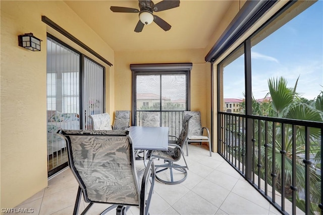 sunroom / solarium featuring plenty of natural light and ceiling fan