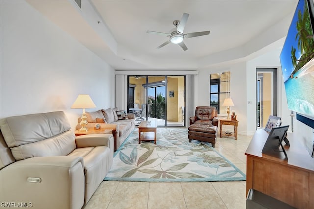 living room with ceiling fan and light tile patterned floors