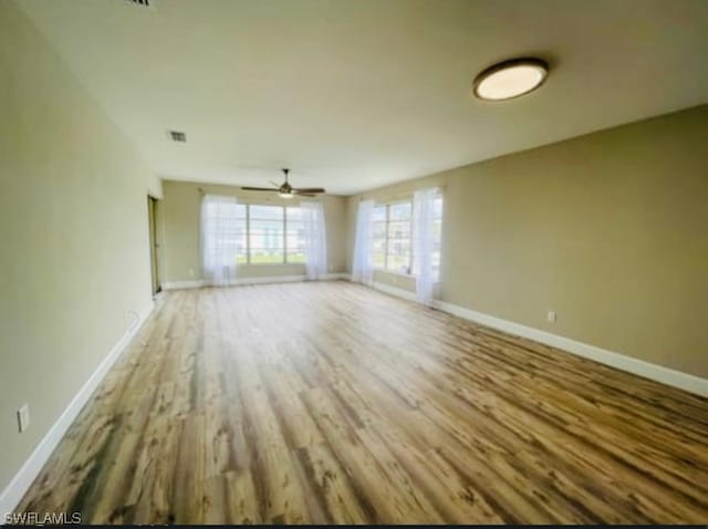 unfurnished living room featuring light hardwood / wood-style floors and ceiling fan